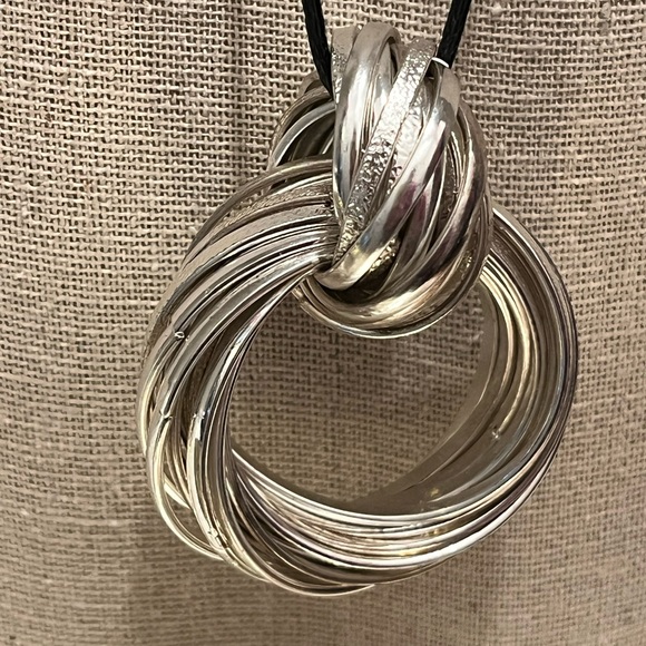 N125 Multiple hammered flat metal strips create a pendant with knot on cord - Picture 8 of 8